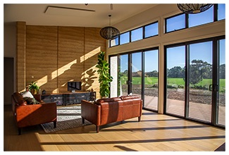 Rammed earth walls as internal thermal mass in living room